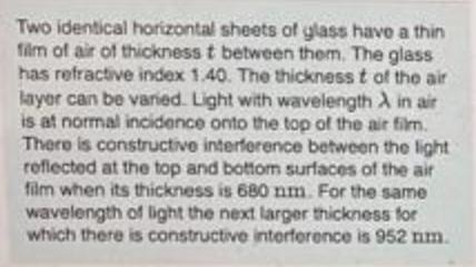 Two identical horizontal sheets of glass have a thin film of air of thickness t between them. The glass has
