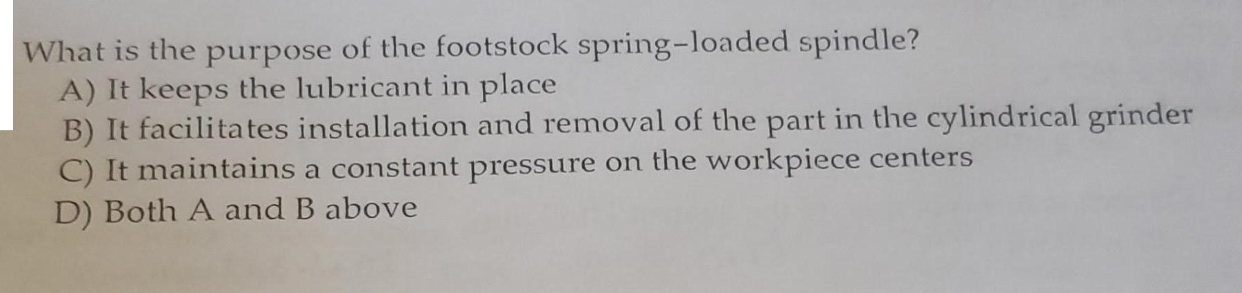 What is the purpose of the footstock spring-loaded spindle? A) It keeps the lubricant in place B) It