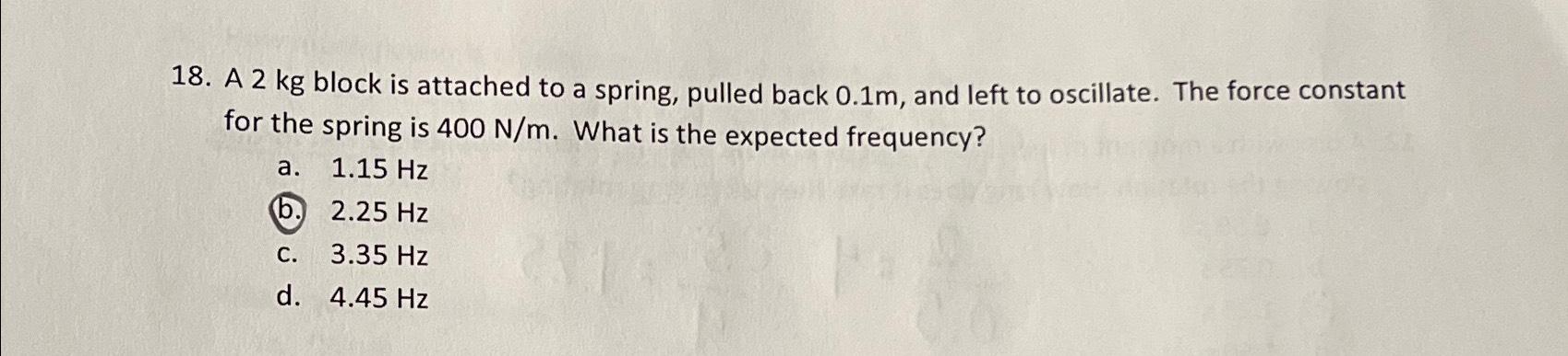 A 2kg block is attached to a spring, pulled back 0.1m,