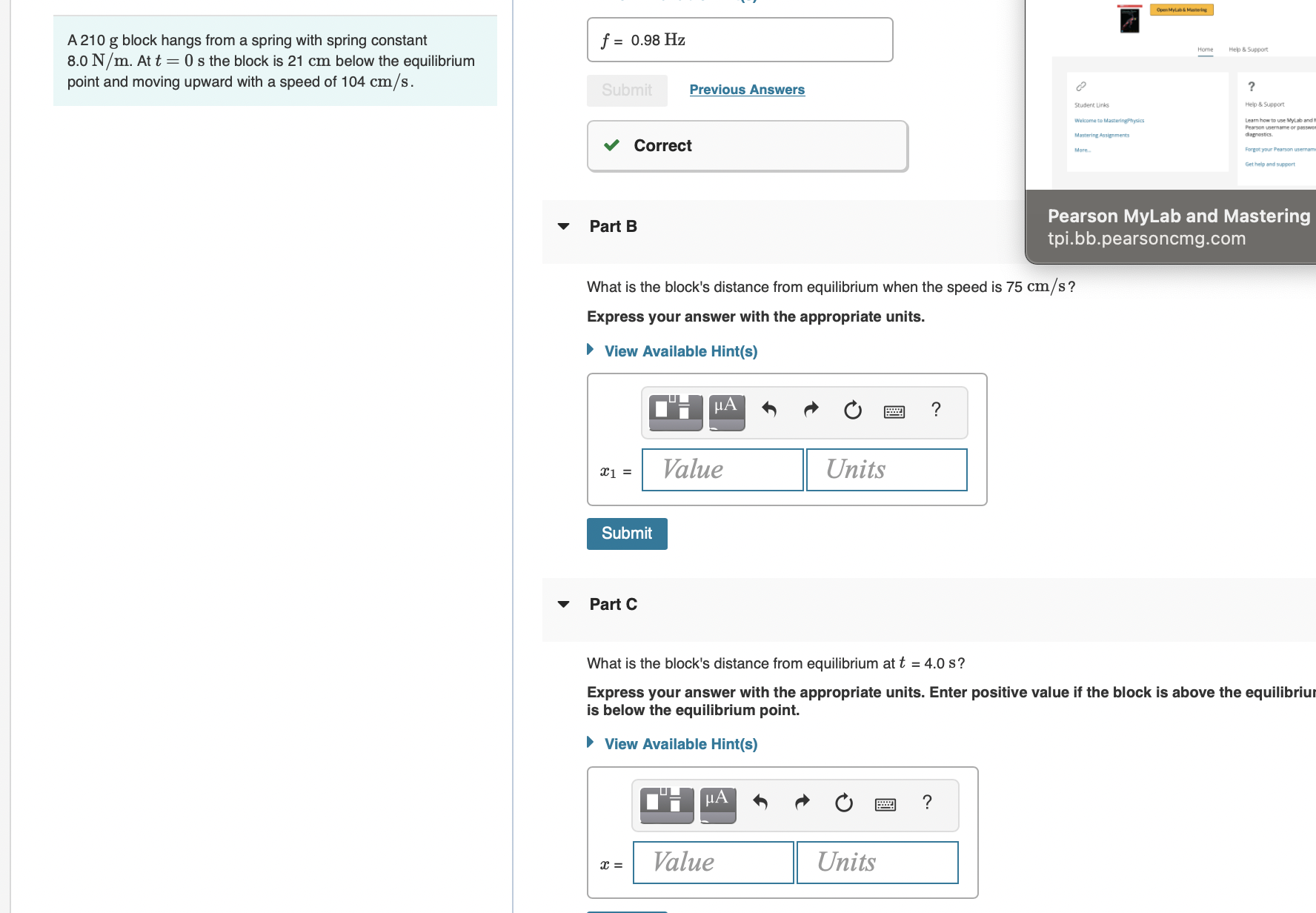  A 210 g block hangs from a spring with spring constant