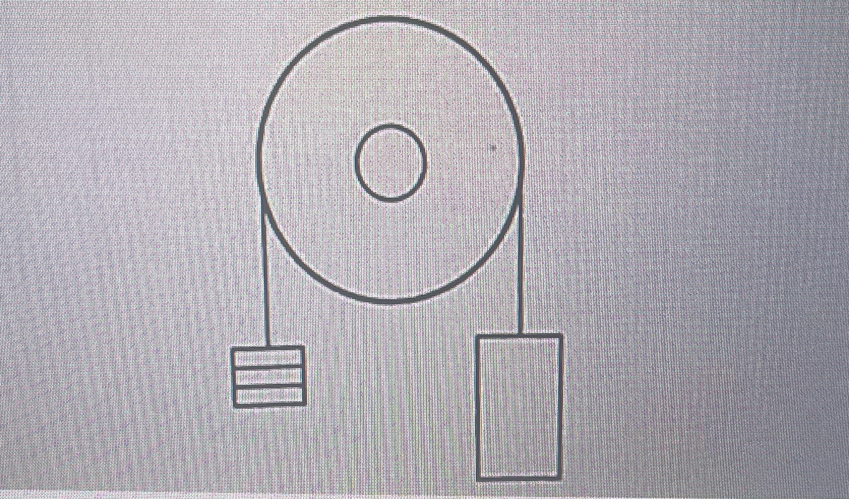 An old-style elevator is connected to a counterweight by a cable that