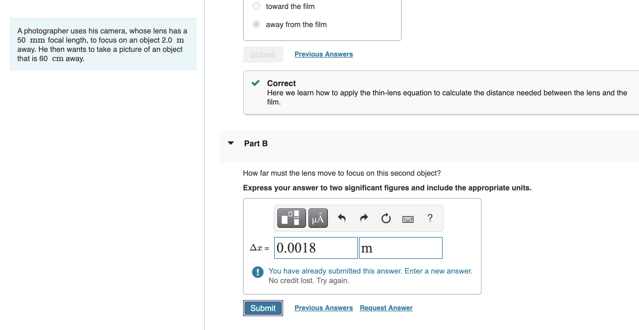  A photographer uses his camera, whose lens has a 50 mm