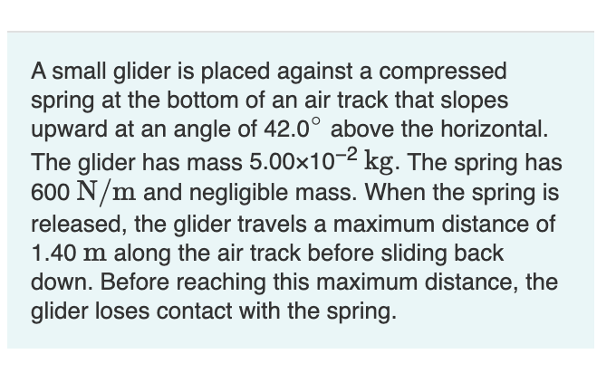 A small glider is placed against a compressed spring at the