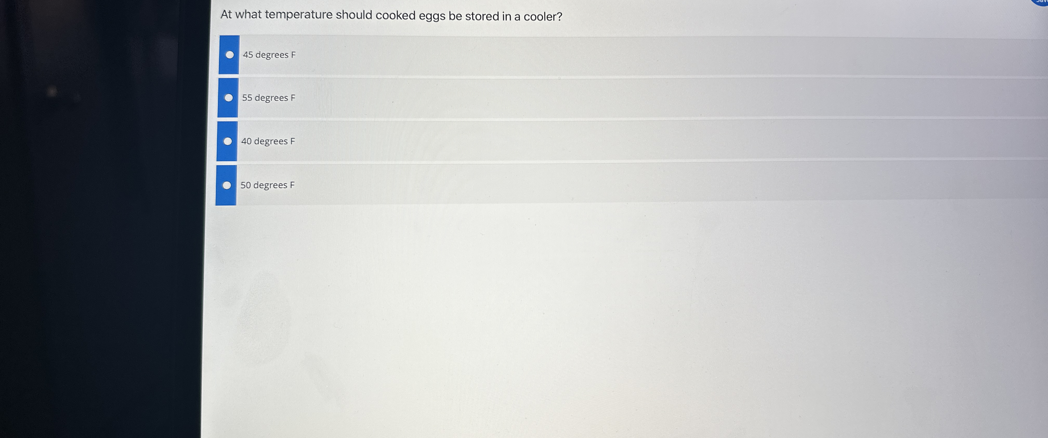  At what temperature should cooked eggs be stored in a cooler?