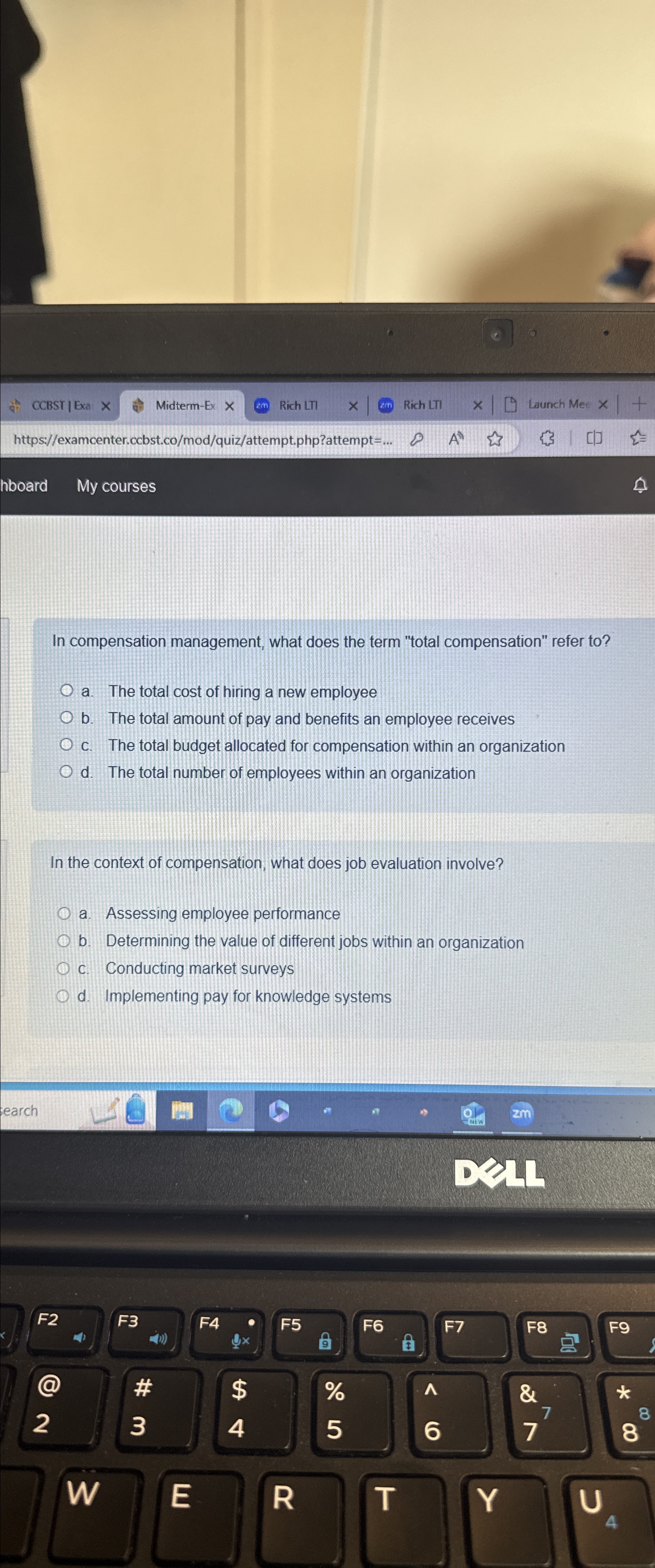  In compensation management, what does the term "total compensation" refer to?