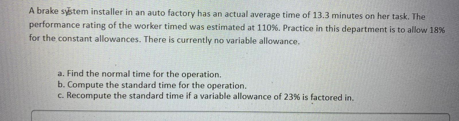 A brake system installer in an auto factory has