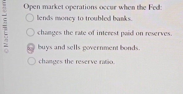Open market operations occur when the Fed: lends
