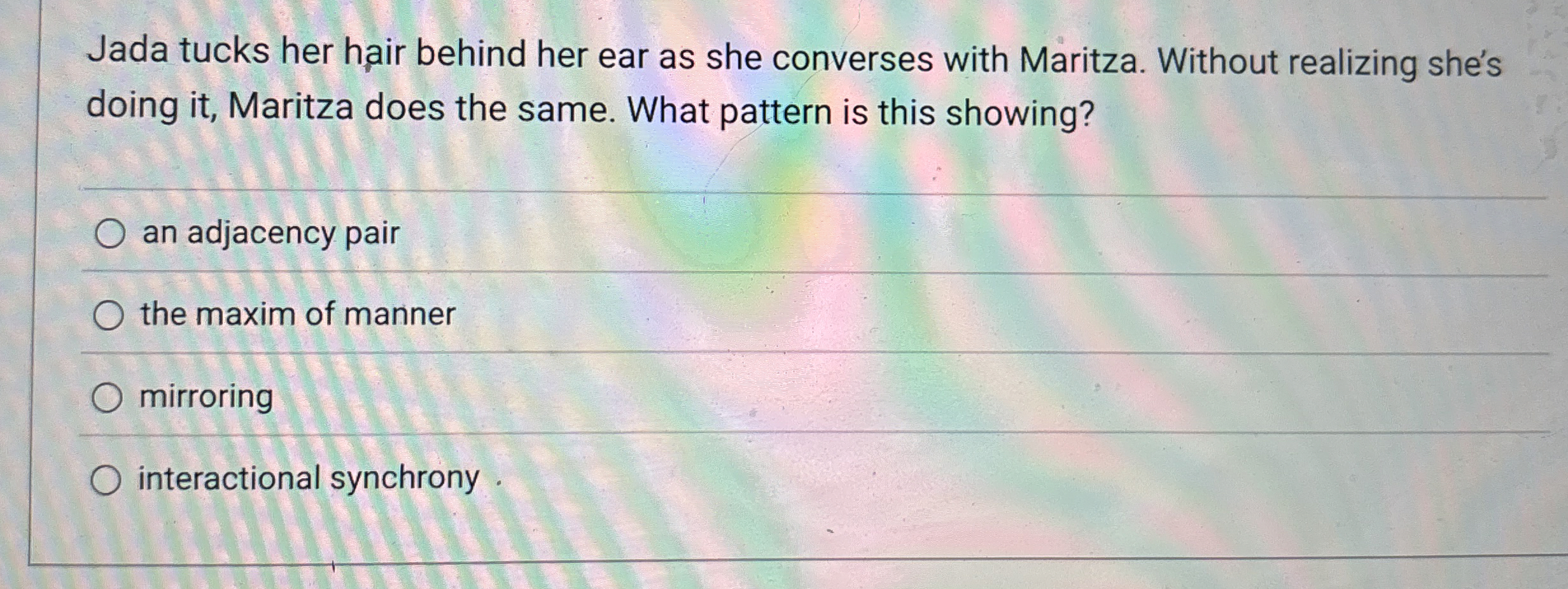 Jada tucks her hair behind her ear as she