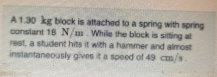 A 1 . 3 0 kg block is attached to a spring with