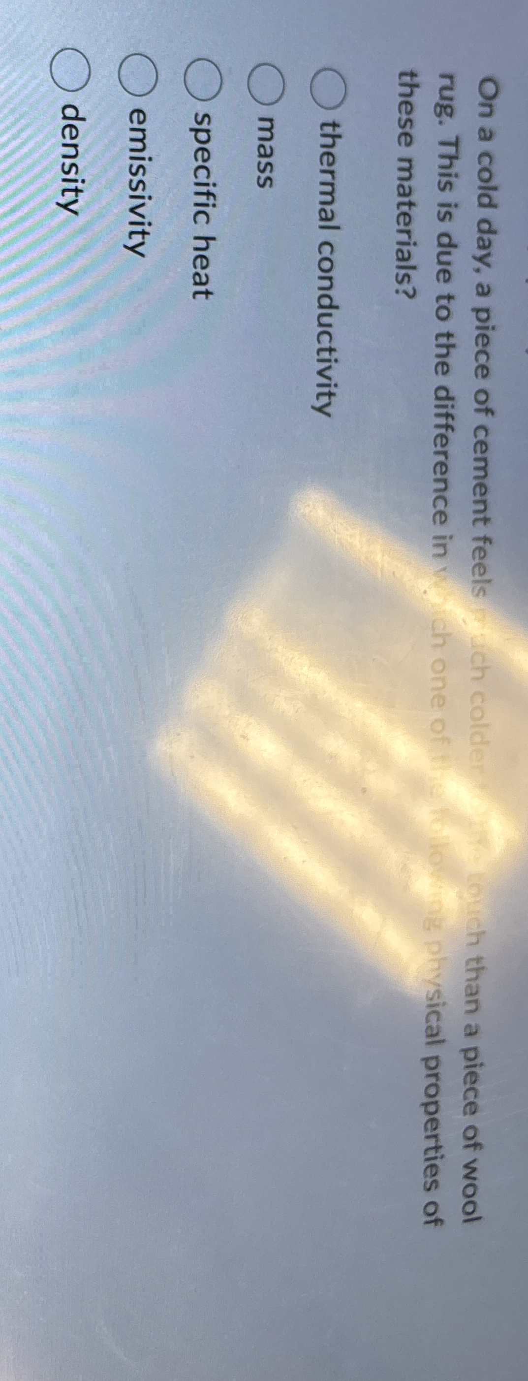 On a cold day, a piece of cement feels which