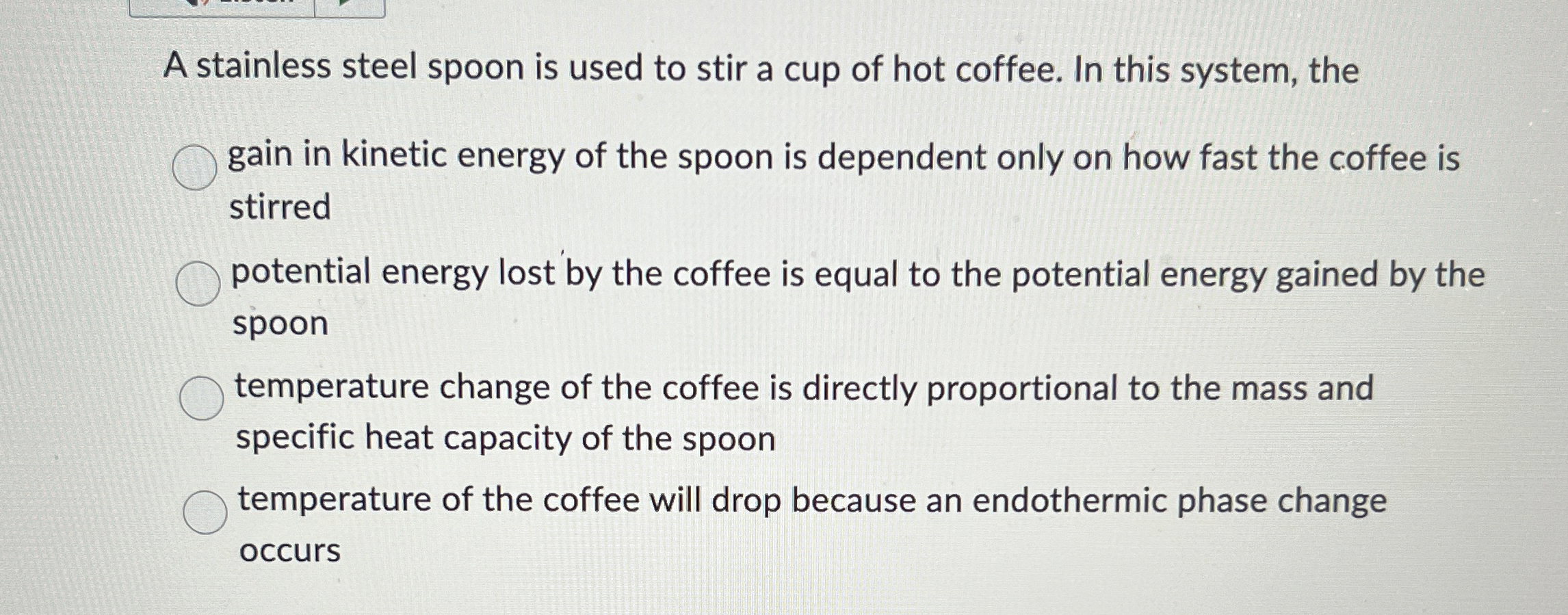 A stainless steel spoon is used to stir a cup of