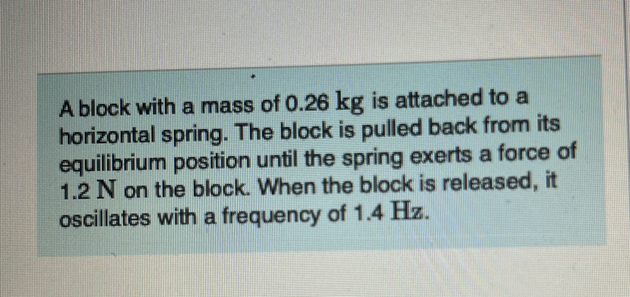 A block with a mass of 0 . 2 6 kg is attached to