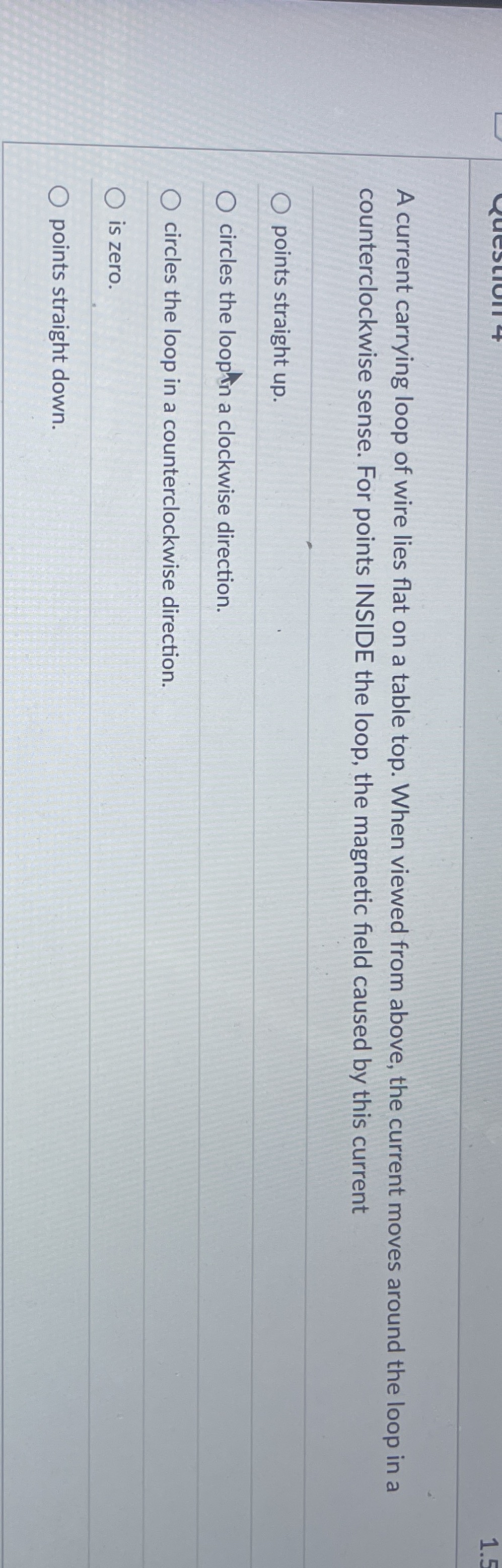 A current carrying loop of wire lies flat on a