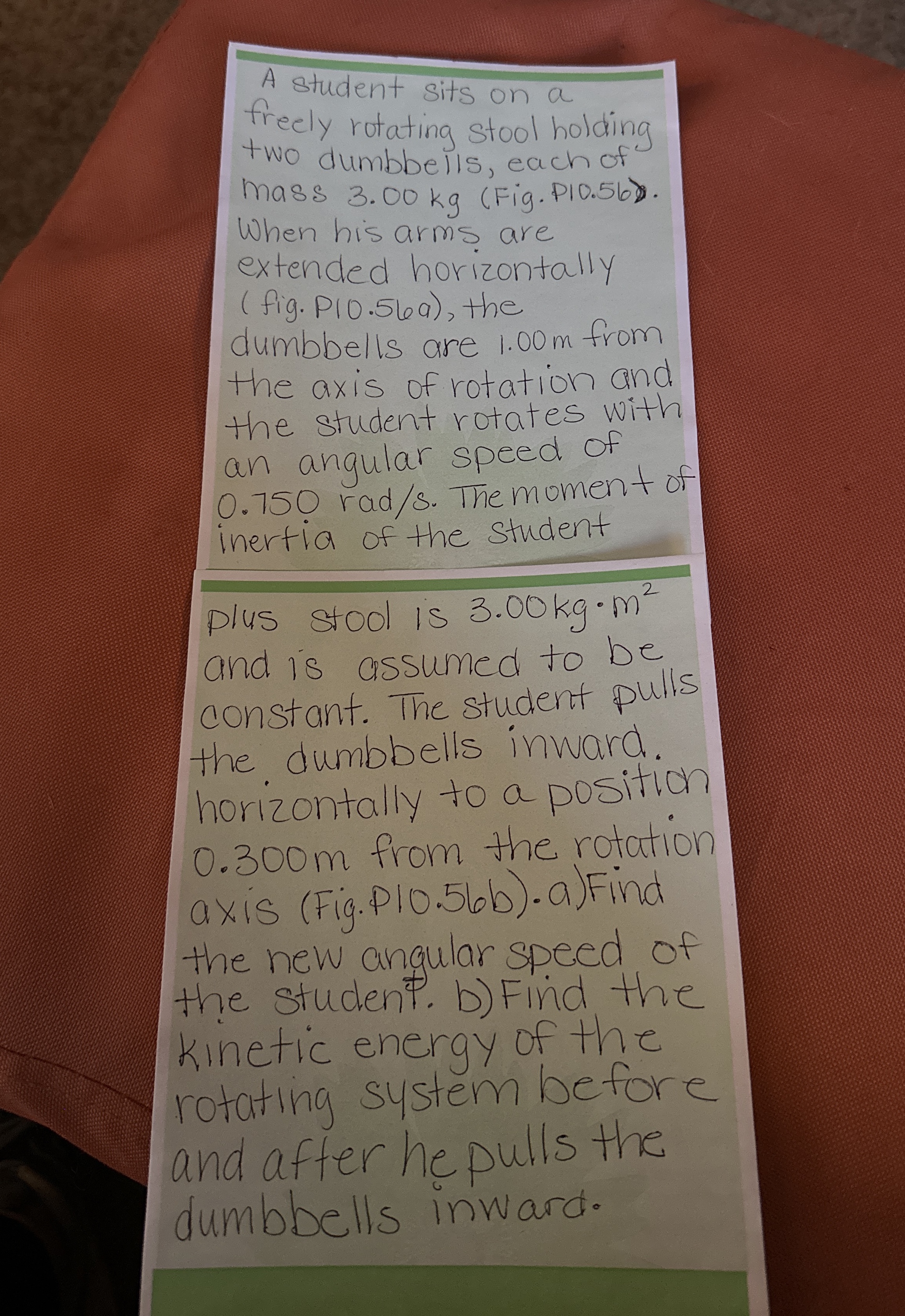 A student sits on a freely rotating stool holding