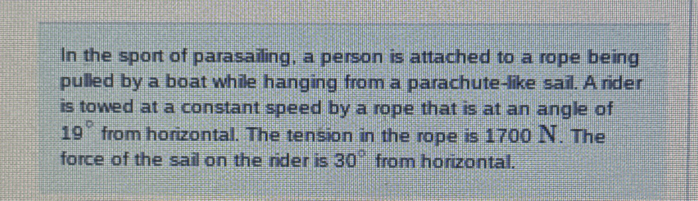 In the sport of parasailing, a person is attached