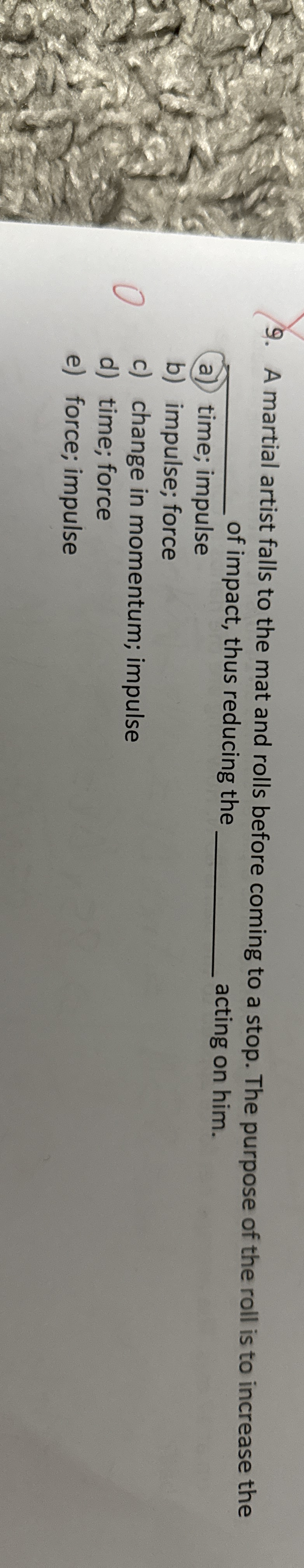 A martial artist falls to the mat and rolls