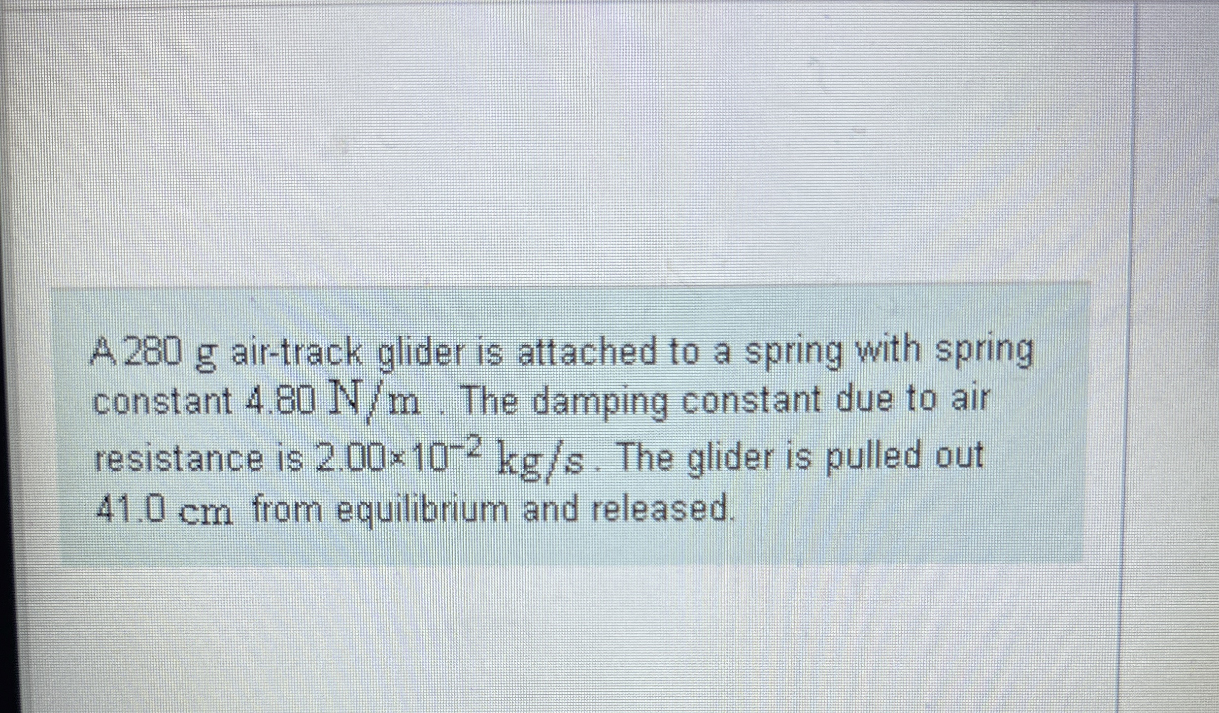 A 2 8 0 g air - track glider is attached to a