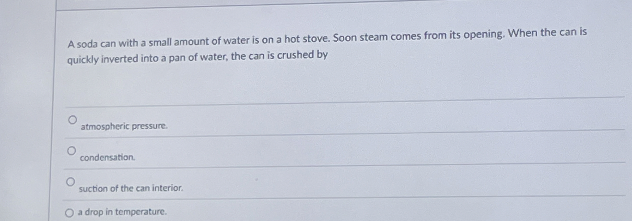 A soda can with a small amount of water is on a