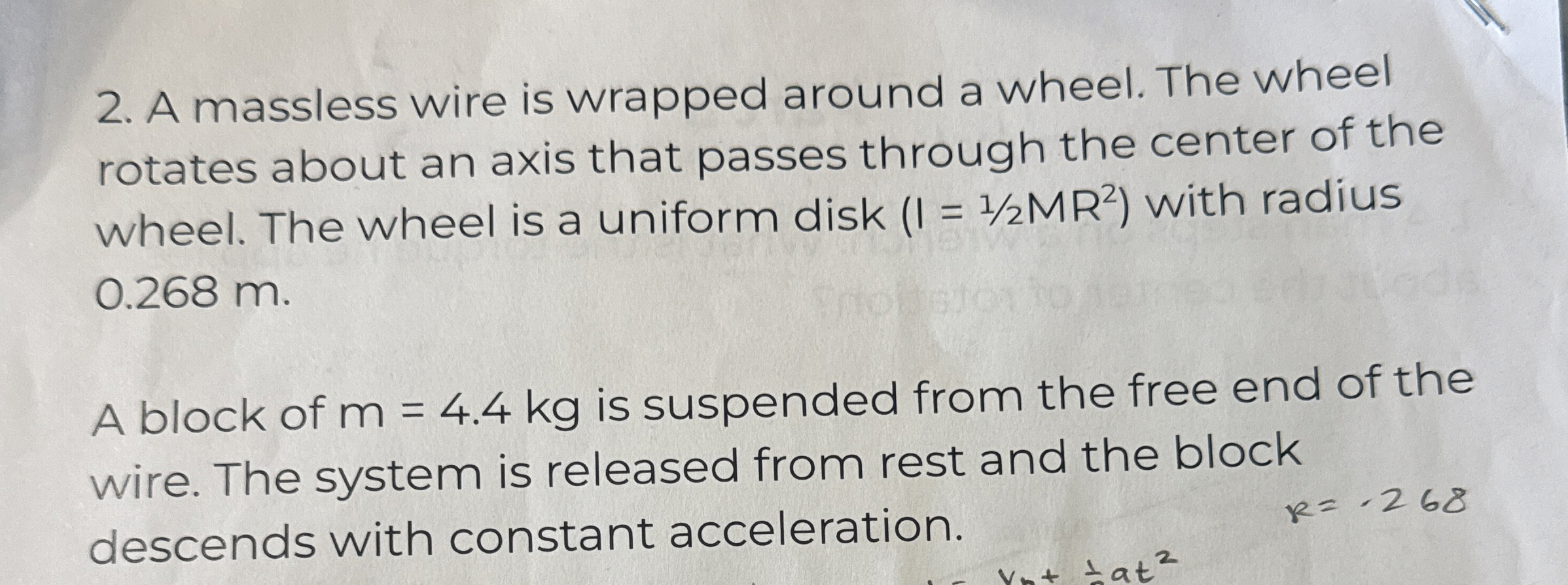 A massless wire is wrapped around a wheel. The