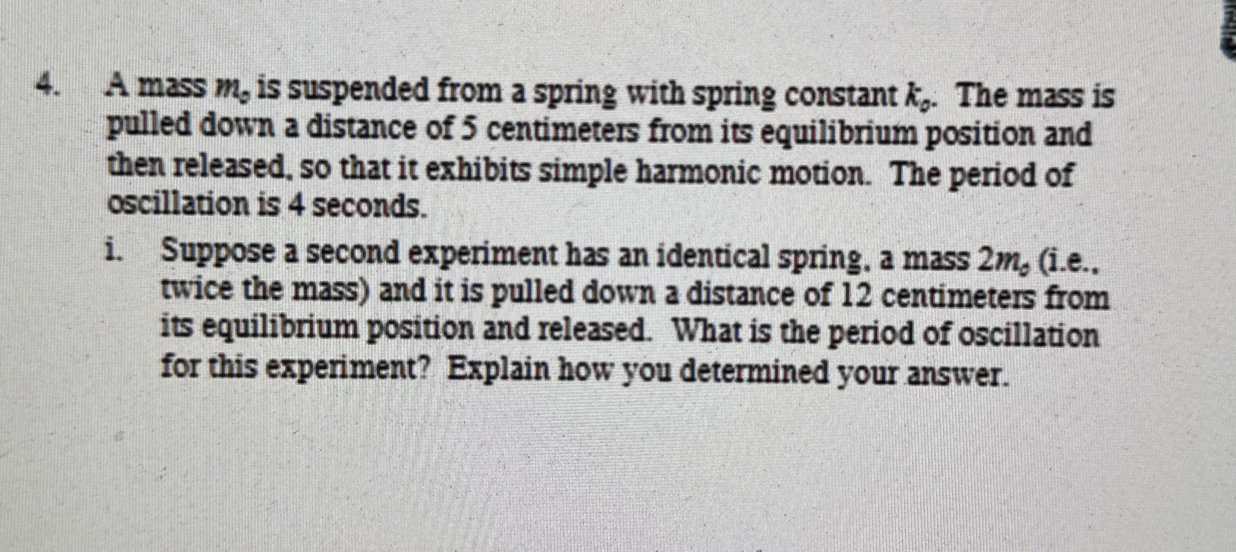 A mass m 0 is suspended from a spring with spring