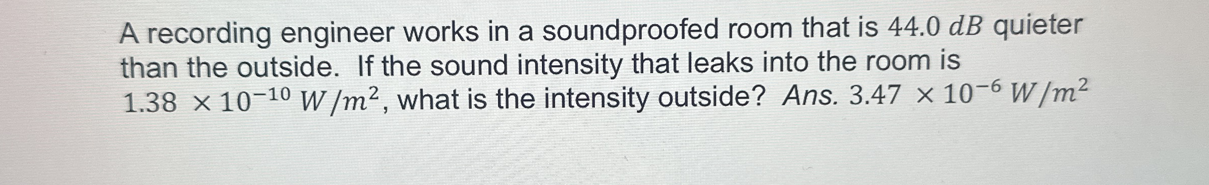 A recording engineer works in a soundproofed room