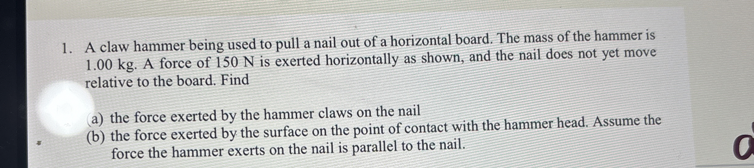 A claw hammer being used to pull a nail out of a