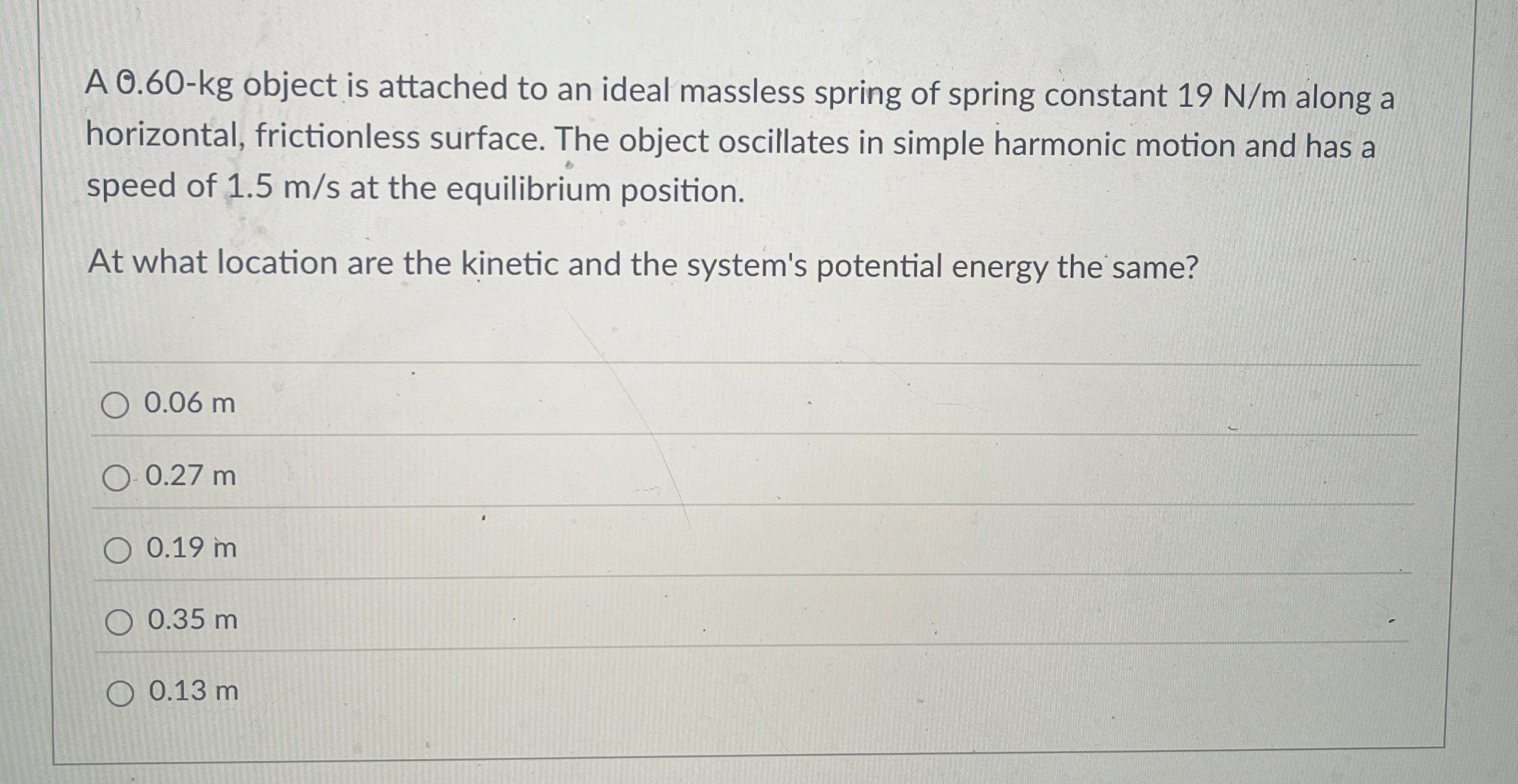A 0 . 6 0 - k g object is attached to an ideal
