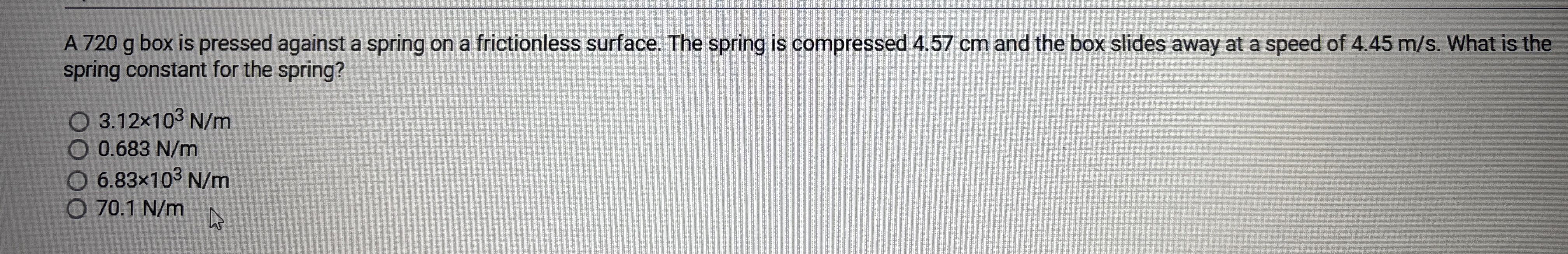 A 7 2 0 g box is pressed against a spring on a