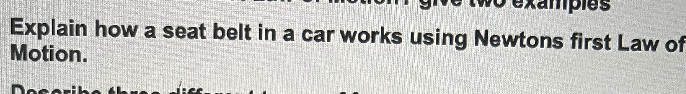 Explain how a seat belt in a car works using