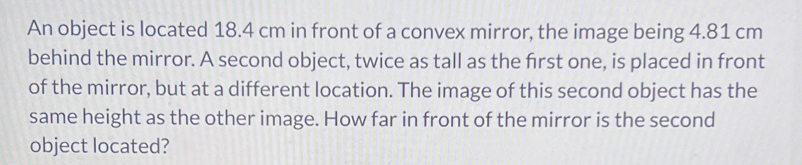 An object is located 1 8 . 4 cm in front of a