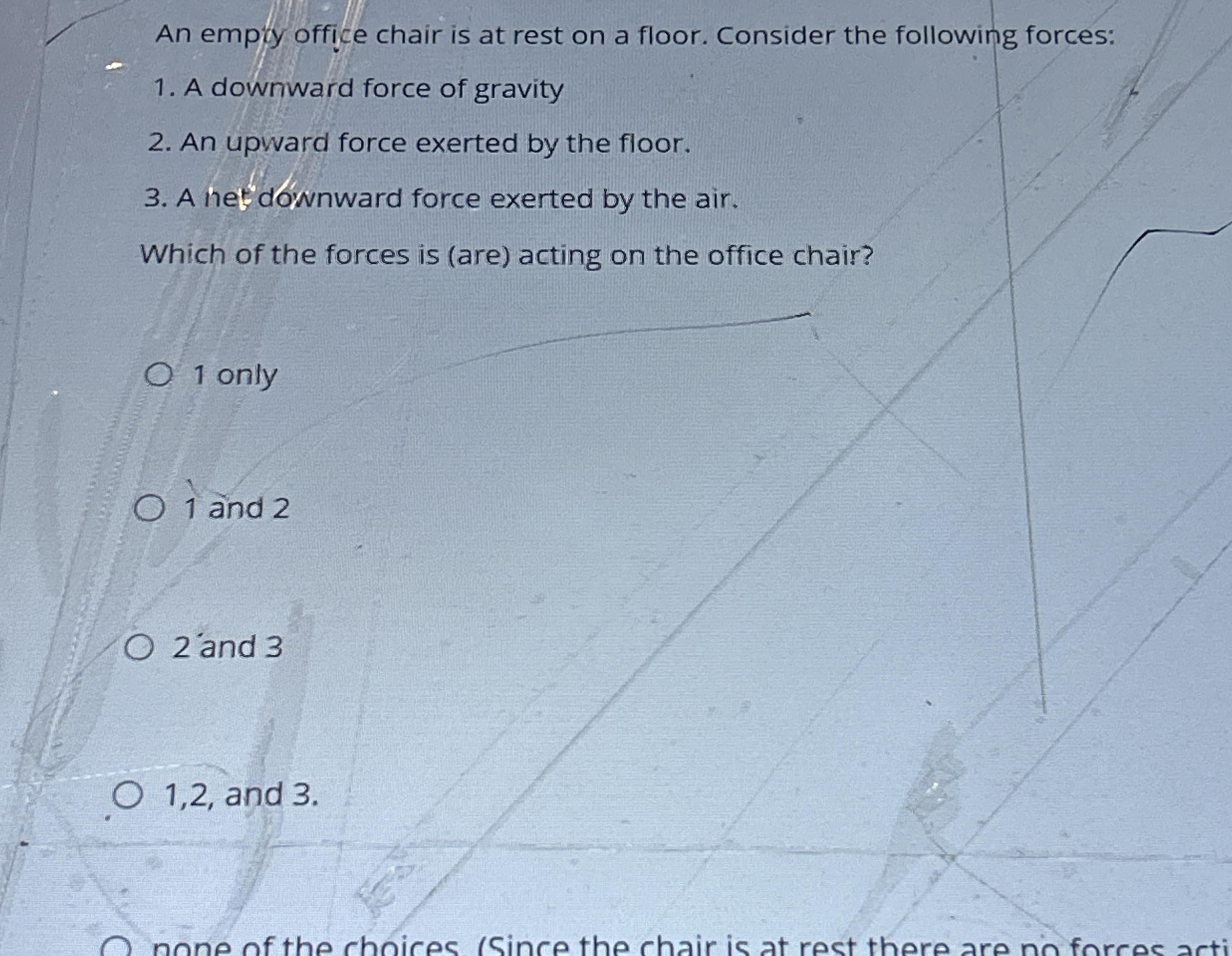 An empiy office chair is at rest on a floor.