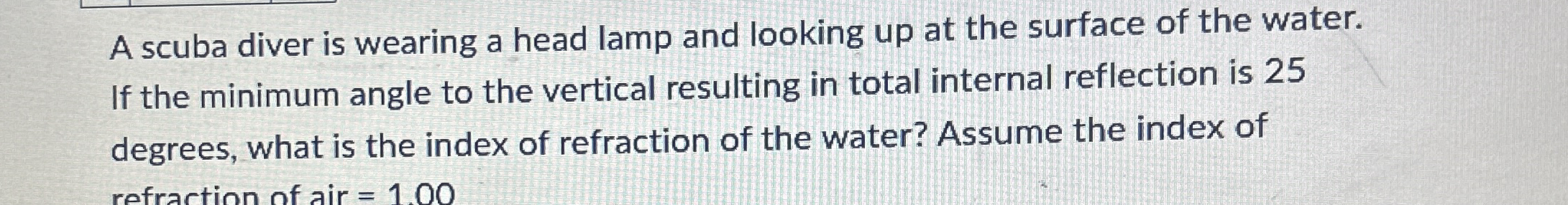 A scuba diver is wearing a head lamp and looking
