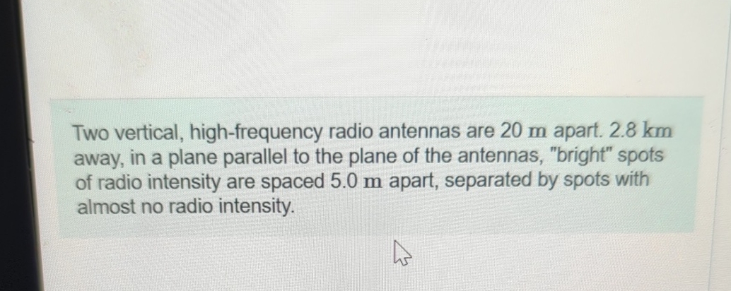 Two vertical, high - frequency radio antennas are