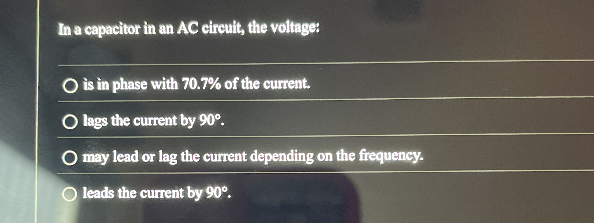 In a capacitor in an AC circuit, the voltage: is