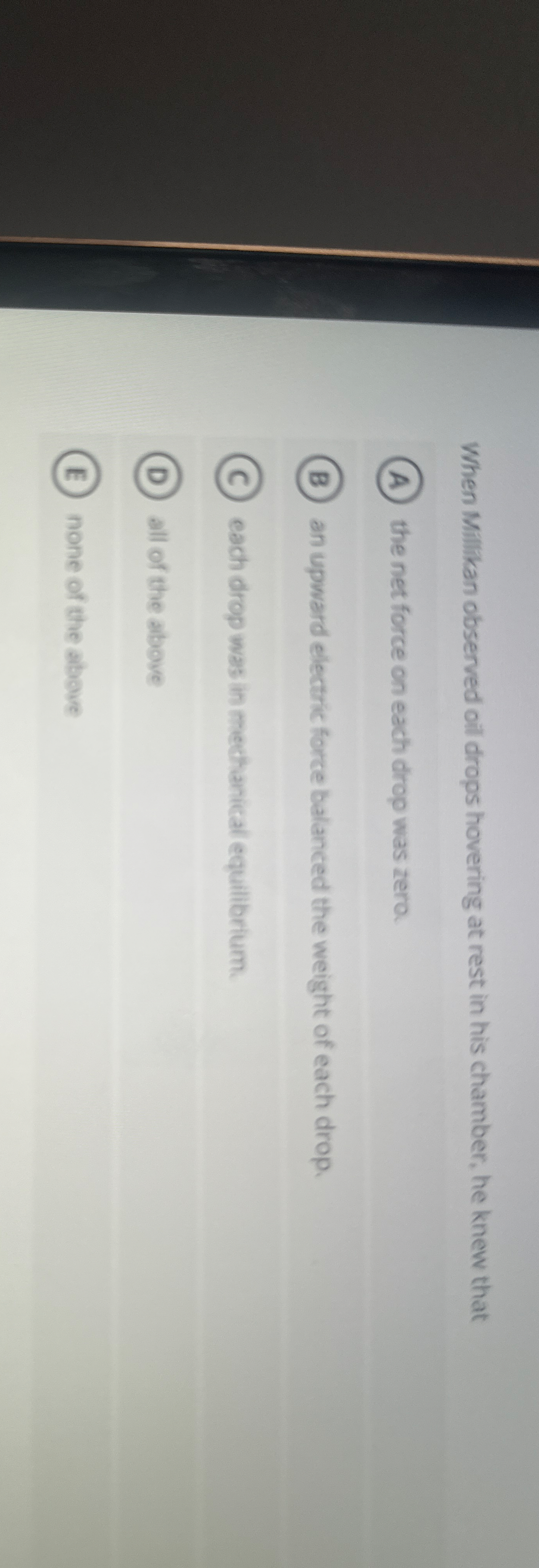 When Millikan observed oil drops hovering at rest