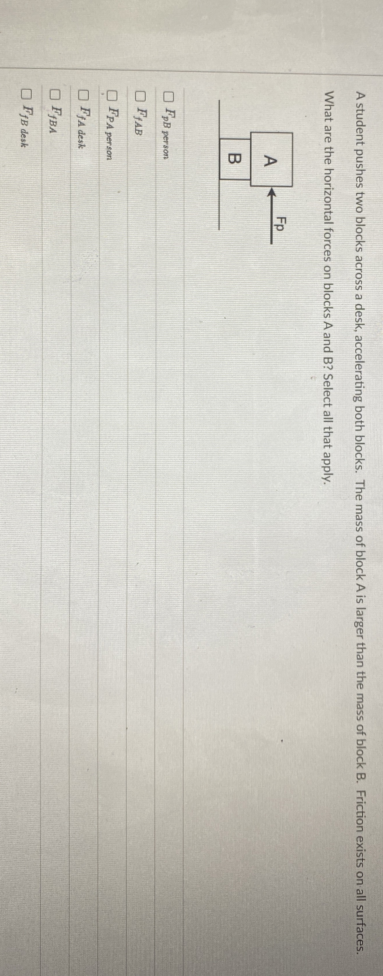 A student pushes two blocks across a desk,