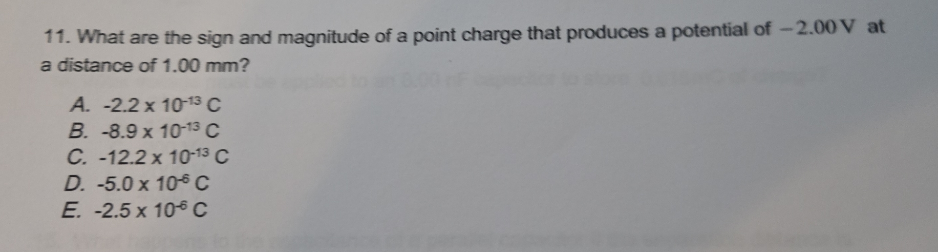 What are the sign and magnitude of a point charge