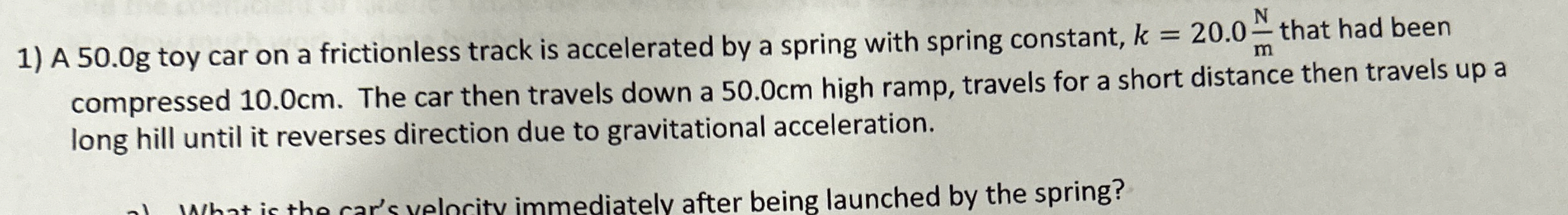 A 5 0 . 0 g toy car on a frictionless track is