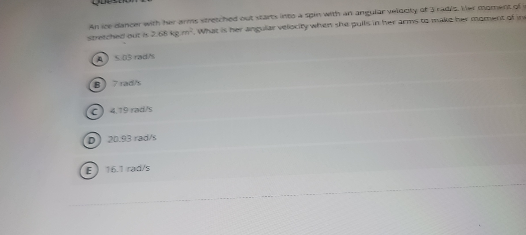 An ice dancer with her arms stretched out stares