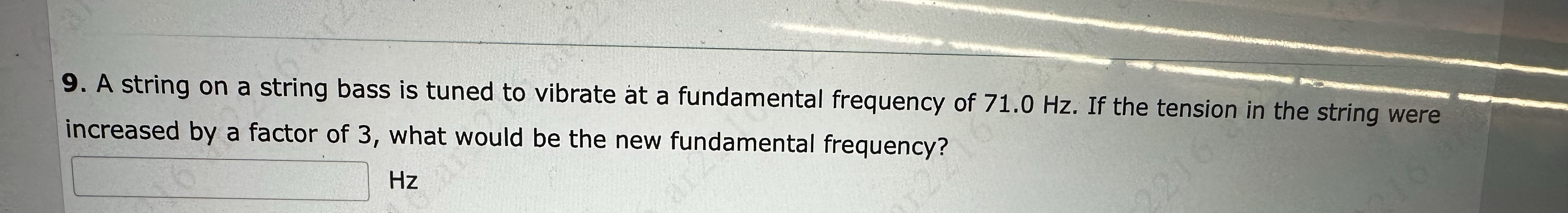 A string on a string bass is tuned to vibrate at