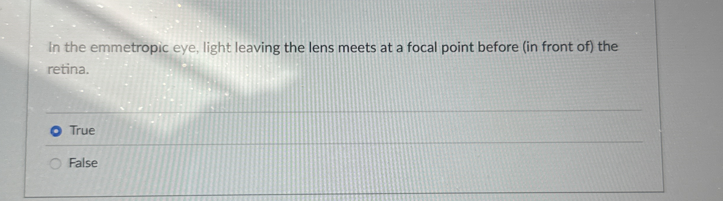 In the emmetropic eye, light leaving the lens