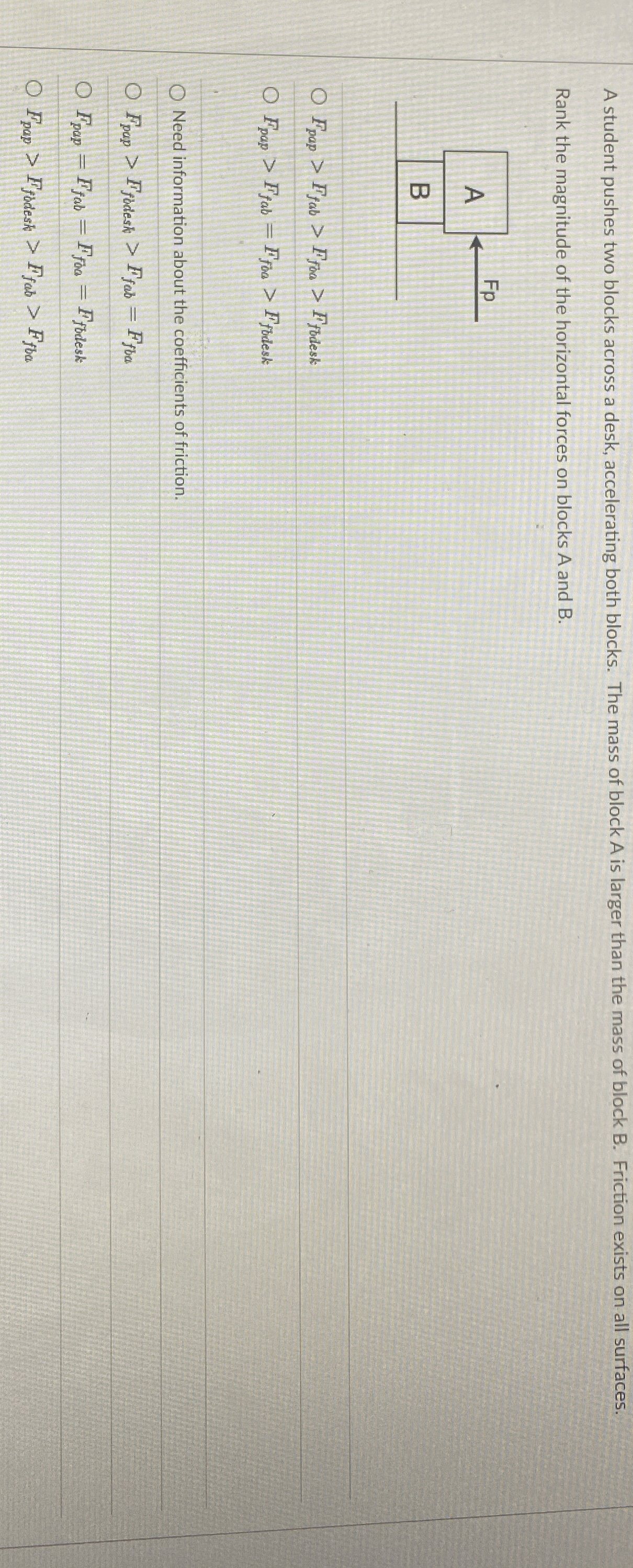 A student pushes two blocks across a desk,