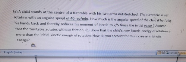 ( a ) A child stands at the centre of a turntable
