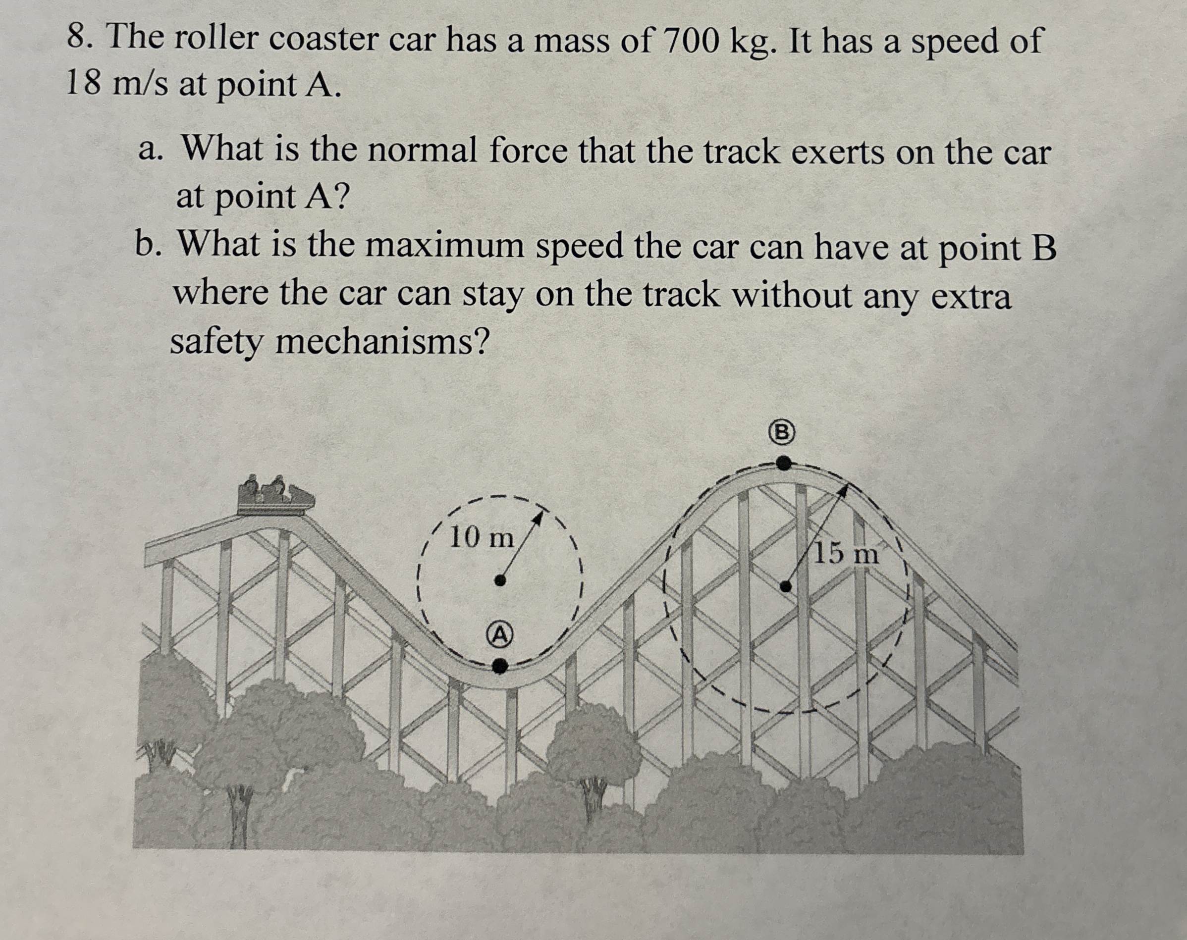 The roller coaster car has a mass of 7 0 0 kg .
