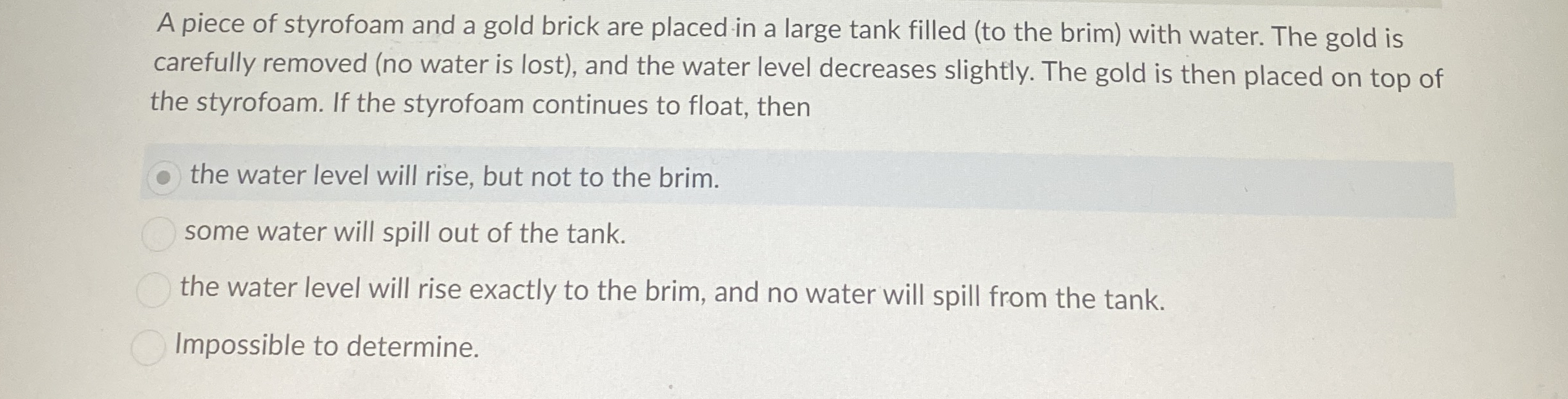 A piece of styrofoam and a gold brick are placed