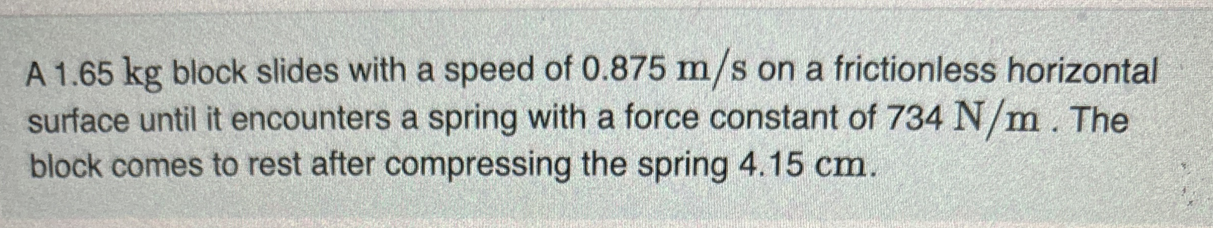 A 1 . 6 5 kg block slides with a speed of 0 . 8 7