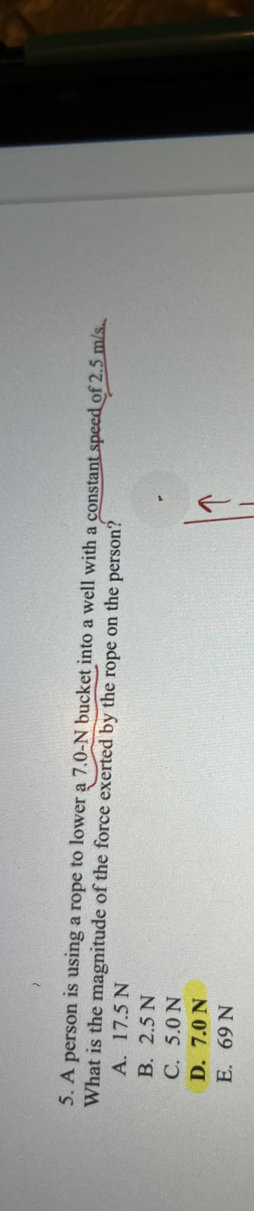 A person is using a rope to lower a 7 . 0 - N