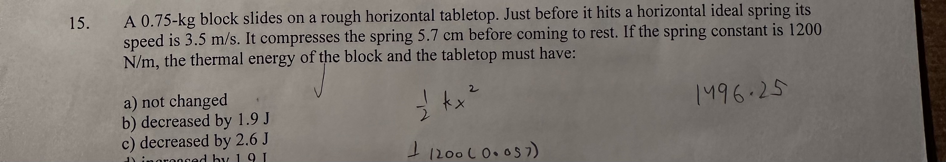 A 0 . 7 5 - k g block slides on a rough