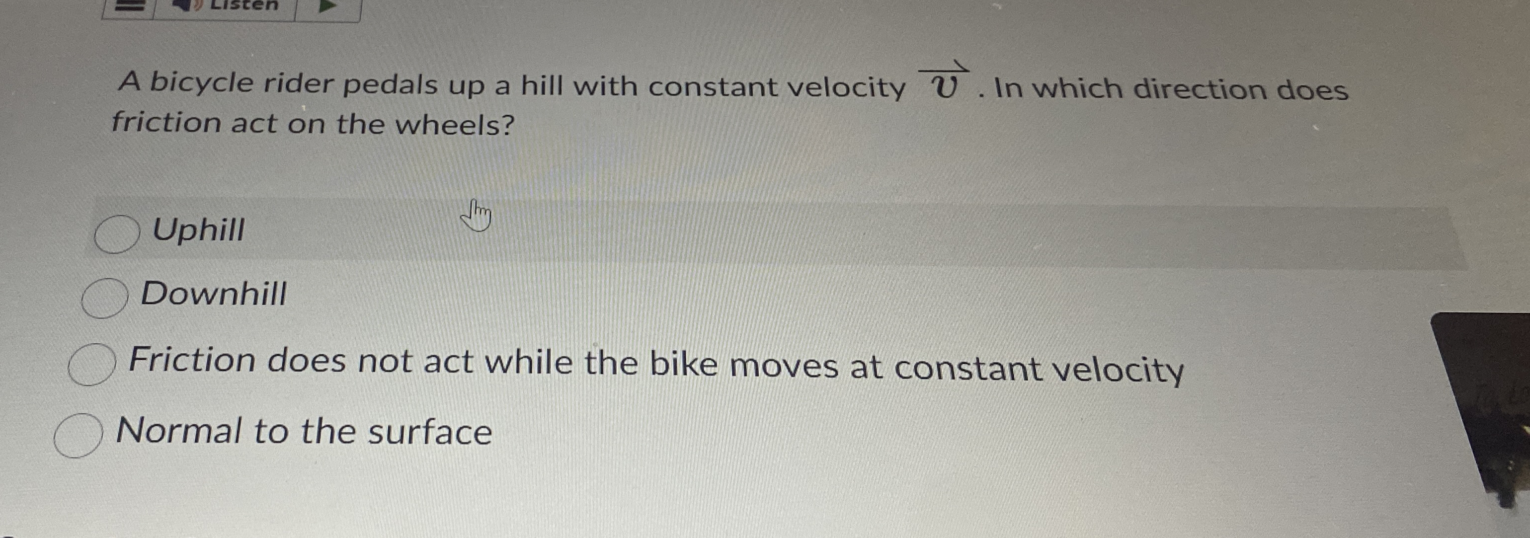 A bicycle rider pedals up a hill with constant