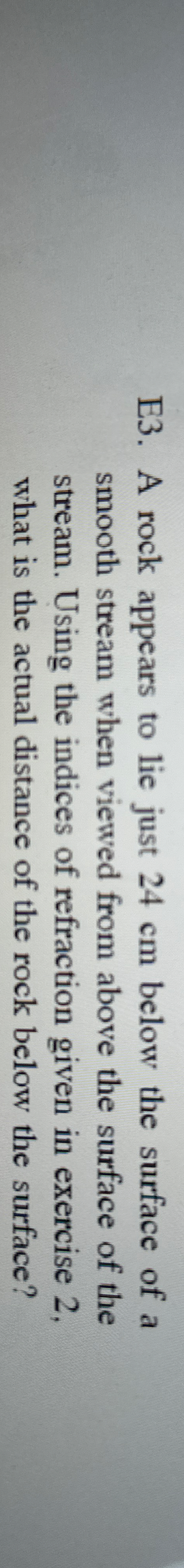 E 3 . A rock appears to lie just 2 4 cm below the